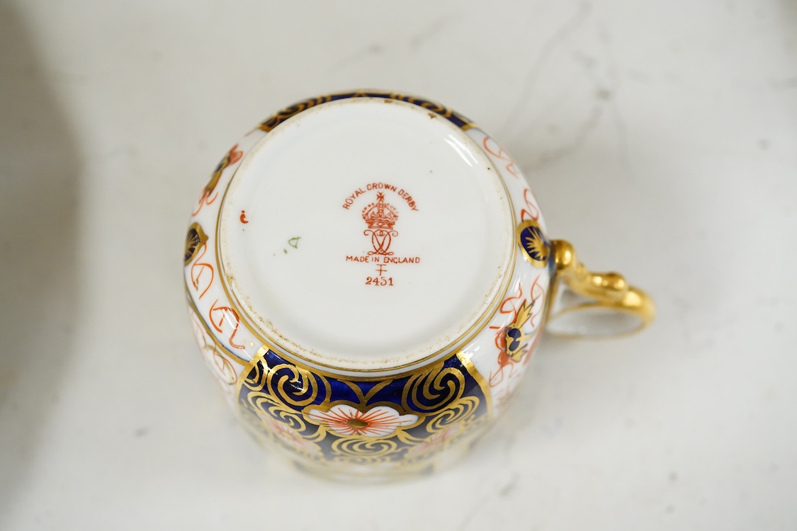 A Crown Derby Imari seven trio place setting, three other cups and two saucers, a large plate and a pair of Doccia- style vases, 18cm high